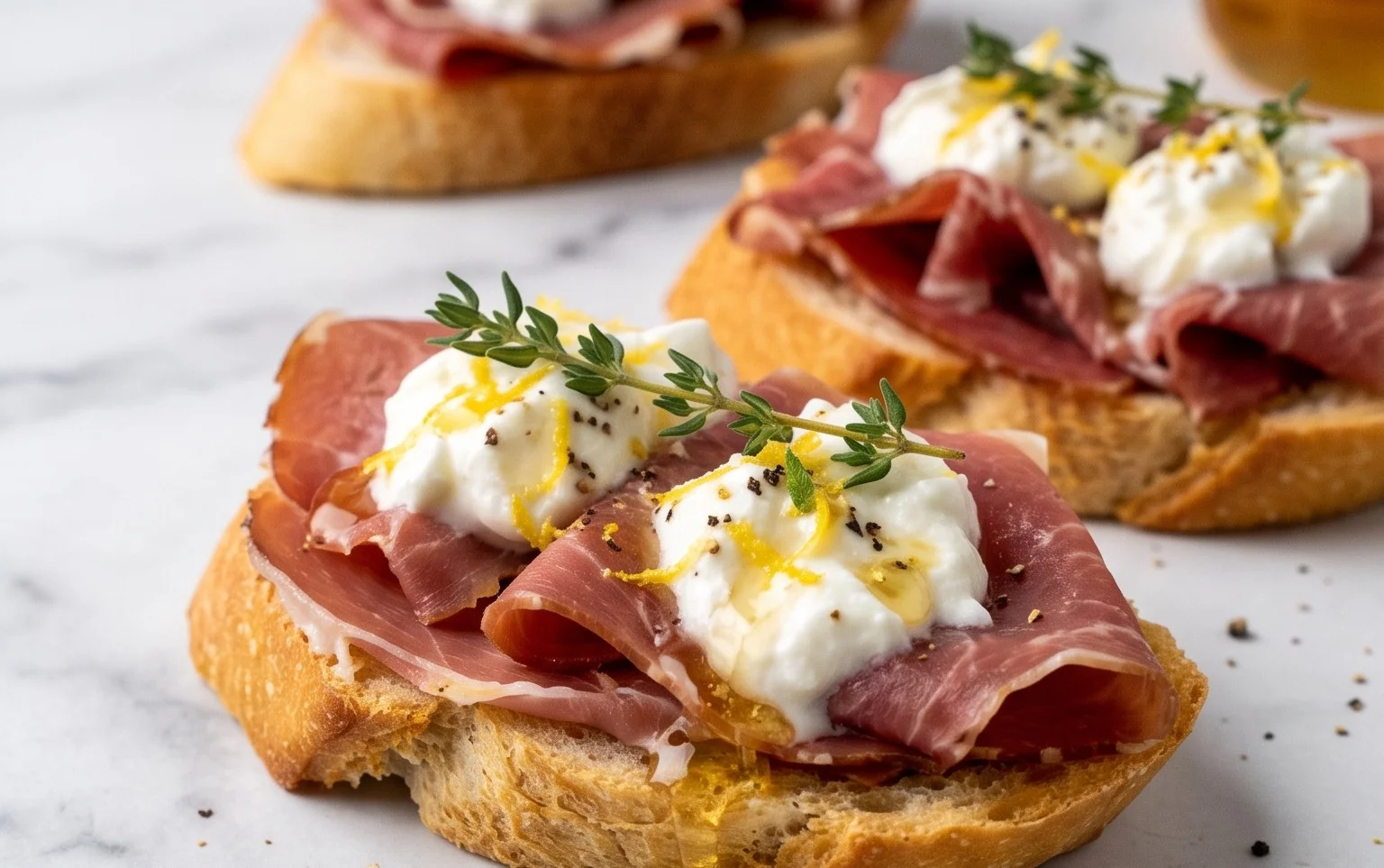Beef Prosciutto Crostini with Burrata and Lemon Honey Drizzle